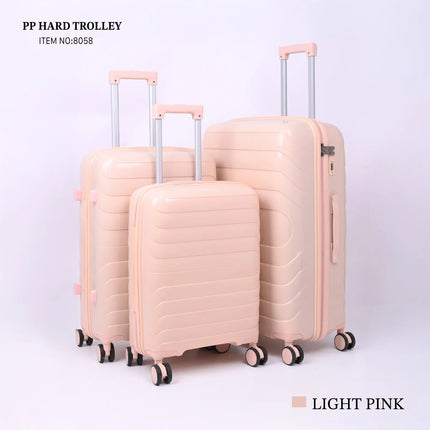 Set of three light pink hard shell trolley suitcases with wheels and telescopic handles.