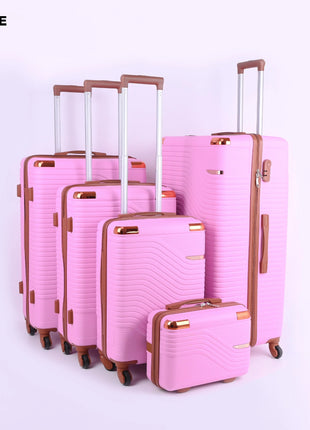 Set of five pink hard-shell suitcases with wheels and brown handles on light background