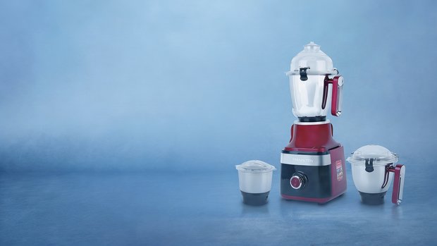 Hamilton style blender with attachments on a blue background