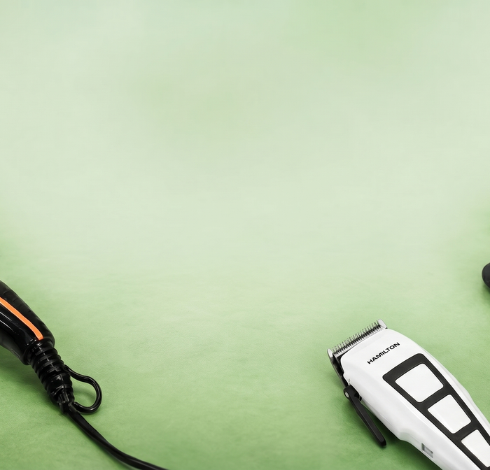 hamilton Hair dryer, hair straightener, and trimmer on a green background